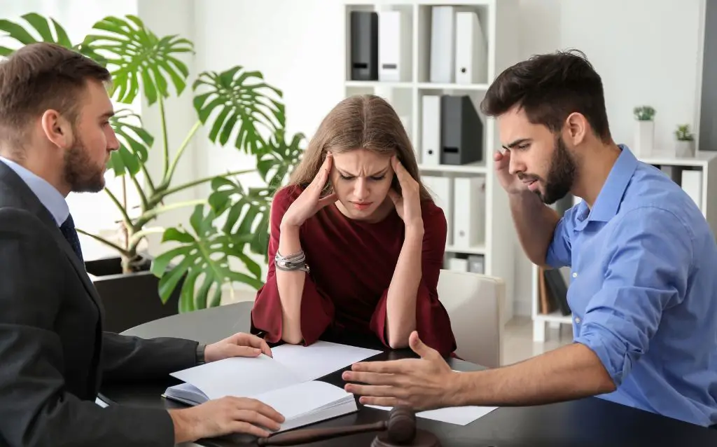 couple with lawyer showing divorce emotion
